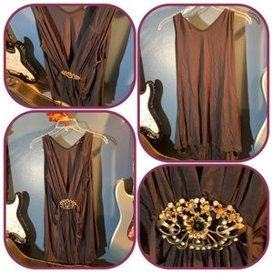 Black midi dress with swooping neckline and metal detail.  Simply Irresistible